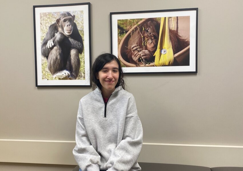 Skye Mingo sits in front of photographs she has taken that now hang up throughout Neshoba General’s Pediatric Clinic.
